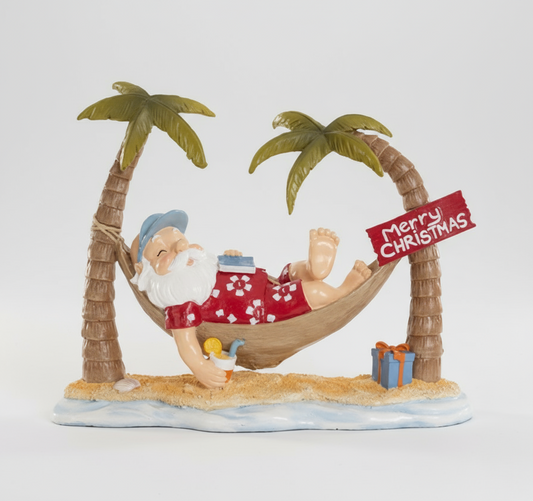 Papai Noel na Praia deitado na Rede